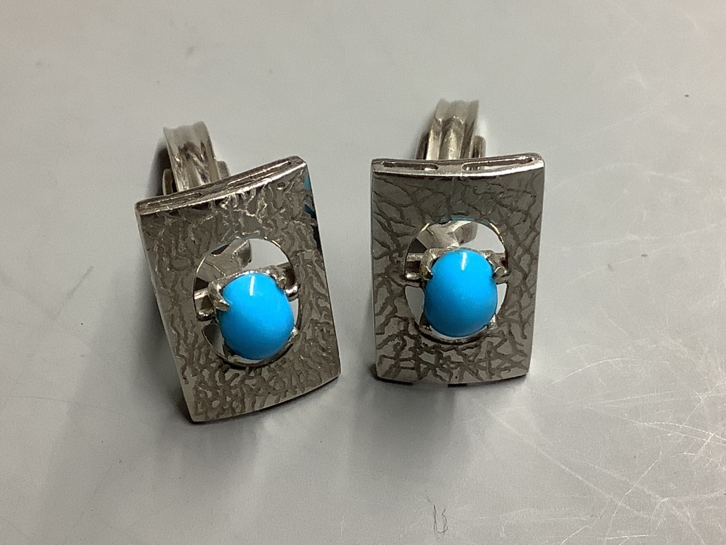 A pair of white metal (tests as 18ct) cufflinks set with turquoise,